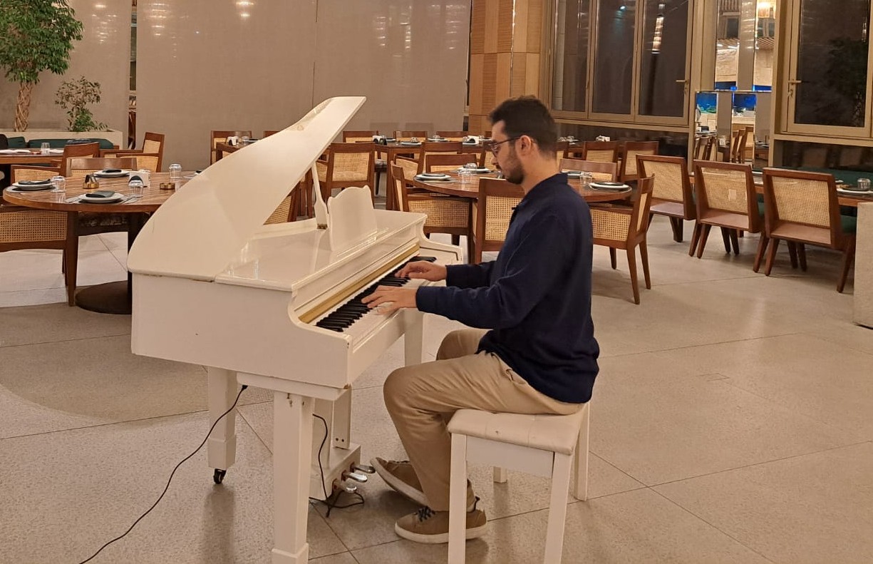 Ghadi Khalil playing a beautiful white grand piano